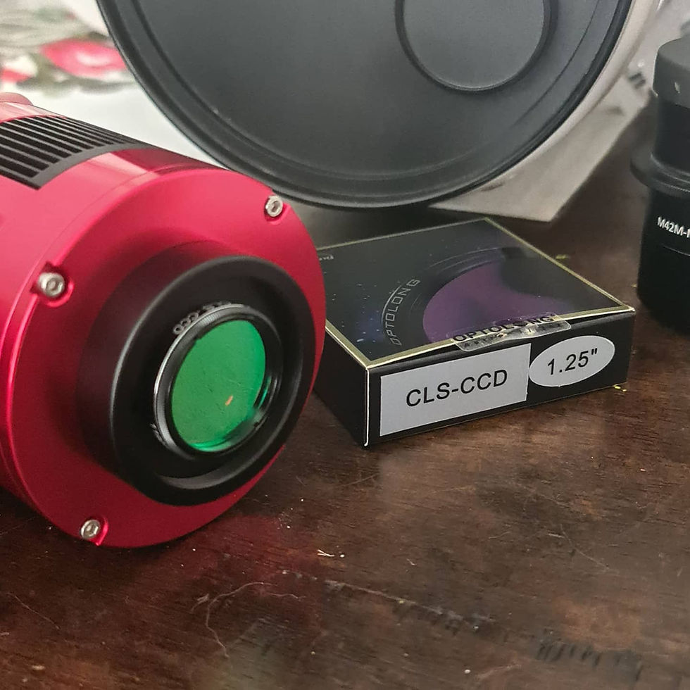 A red ASI533 camera on a table with a filter case next to it